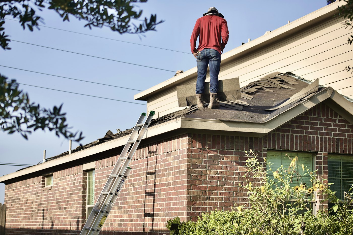 Roofer standing on a roof during a tear-off